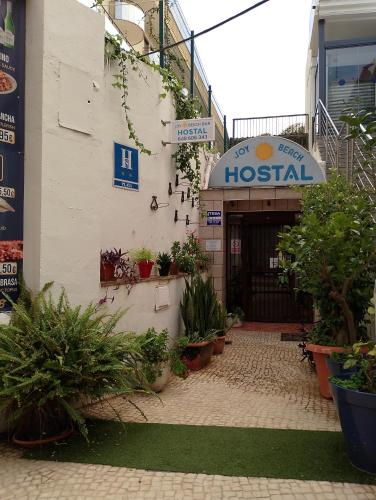 a hospital with potted plants in front of a building at Joy Beach B&B in Torremolinos