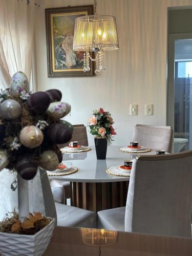 a dining room with a table and chairs and a chandelier at Apartamento Hardt in Pomerode