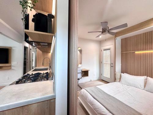 a bedroom with a bed and a kitchen with a stove at Titus Retreat in San Diego