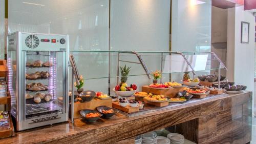a buffet of food on a counter in a room at Holiday Inn Queretaro Zona Krystal by IHG in Querétaro
