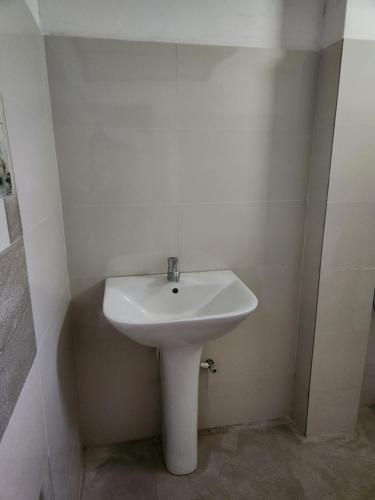 a bathroom with a white sink in a room at Silvil Homestay in Bandarawela