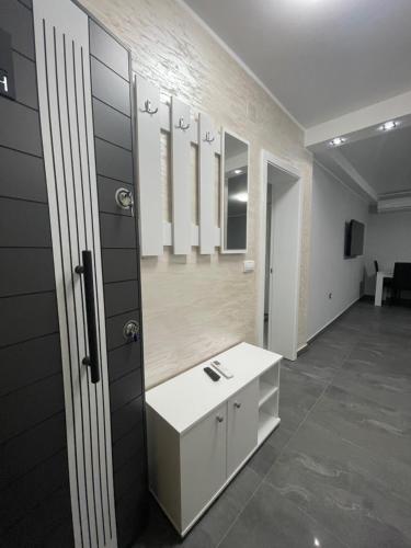 a bathroom with a sink and mirrors on the wall at Vila Mila Ćirić in Pančevo