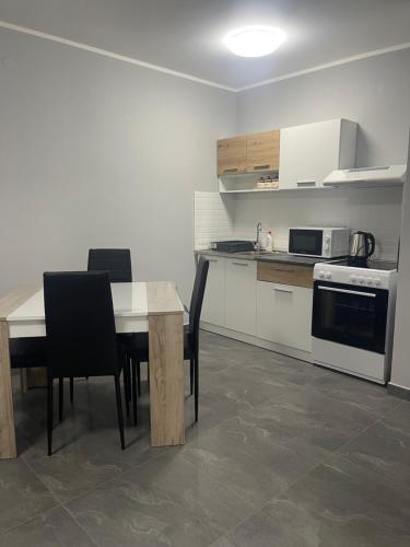 a kitchen with a table and chairs and a stove at Vila Mila Ćirić in Pančevo