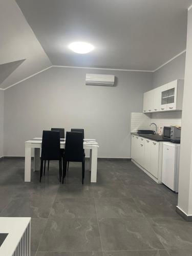 a kitchen with a table and chairs in a room at Vila Mila Ćirić in Pančevo