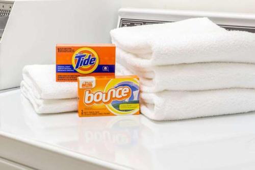 a pile of towels and a box of cleaner on a counter at Sleep Inn Tinley Park I-80 near Amphitheatre-Convention Center in Tinley Park