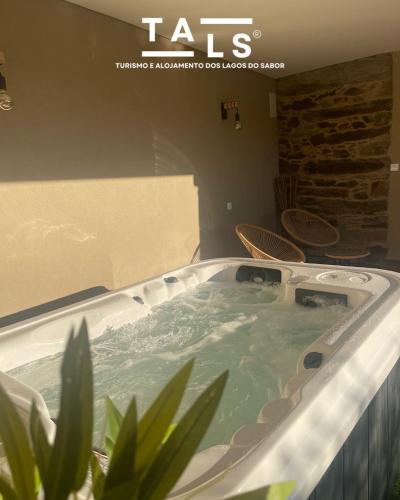 a jacuzzi tub in a room with plants at Turismo e Alojamento dos Lagos do Sabor - Piscina & SPA in Meirinhos