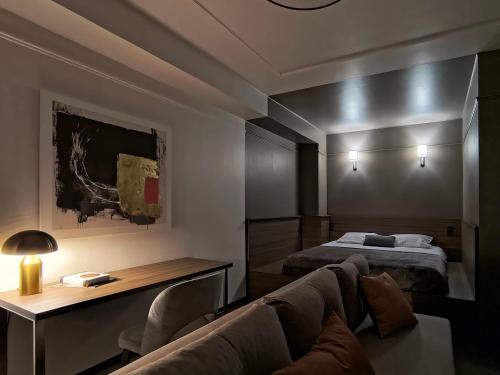 a living room with a couch and a bed at Mini Hotel on Brovarskaya in Kyiv