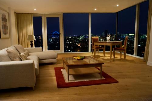 a living room with a view of a city at night at Marlin Apartments London Bridge - Empire Square in London