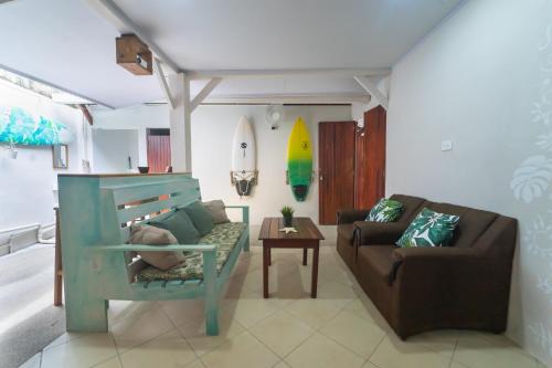 a living room with a couch and a chair at The Cafecito Surfhouse - Santa Teresa in Santa Teresa Beach