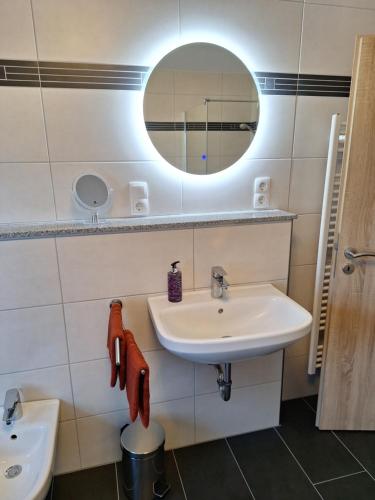 a bathroom with a sink and a mirror at Neue Ferienwohnung auf dem Land in Boppard