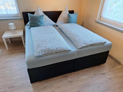 a bed with two pillows on it in a room at Neue Ferienwohnung auf dem Land in Boppard