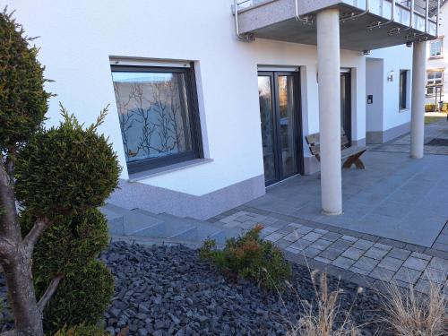 a white house with a window and a porch at Neue Ferienwohnung auf dem Land in Boppard
