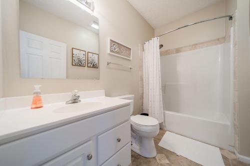 a white bathroom with a sink and a toilet at Whiskey Way Inn in Candler