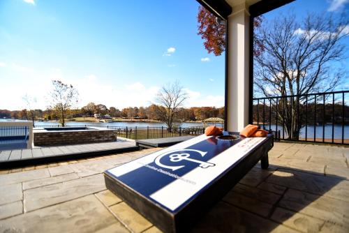 a bed on a patio with a view of the water at Luna's Lake Life in Terrell