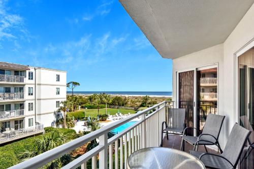 a balcony with chairs and a view of the ocean at Beach Club 327 in East End