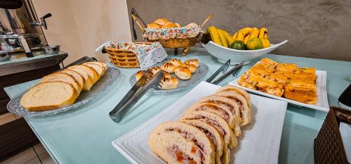 a table with bread and other foods on it at Hotel Parati in Parapuã