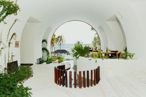 an external view of a white building with an archway at Camino Real Zaashila Huatulco in Santa Cruz Huatulco