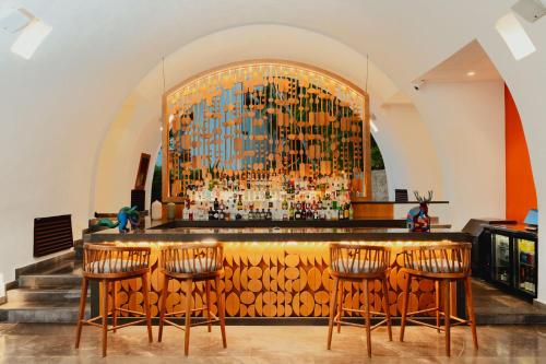 a bar with a large wall of bottles at Camino Real Zaashila Huatulco in Santa Cruz Huatulco