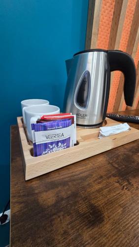 a table with a coffee pot and packets of toothpaste at Pensjonat Lubianka in Starachowice