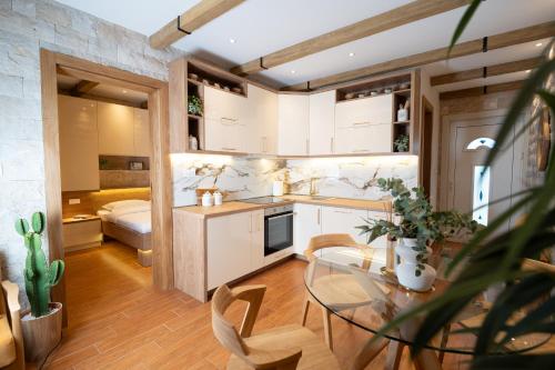 a kitchen and living room with a glass table at 42° North Apartments in Tivat