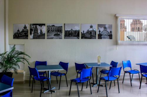 a waiting room with blue tables and blue chairs at Holiday Inn Express Morelia Centro Historico in Morelia