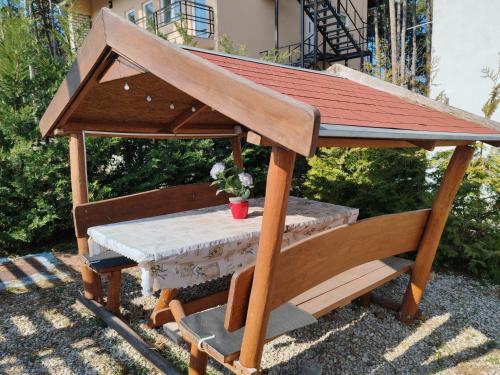 a wooden gazebo with a table at Villa Alex in Siófok