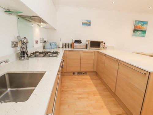 a kitchen with a sink and a counter top at 9 Headland Point in Newquay