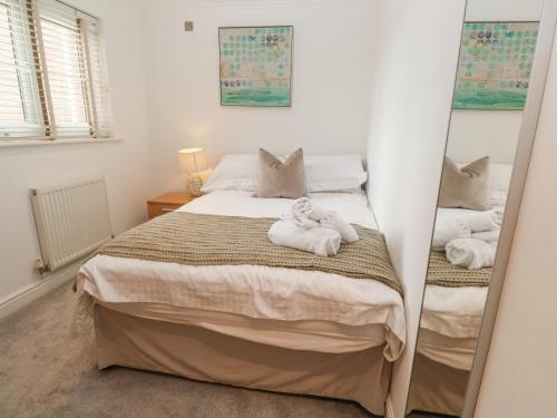 a bedroom with a bed with towels on it at 9 Headland Point in Newquay