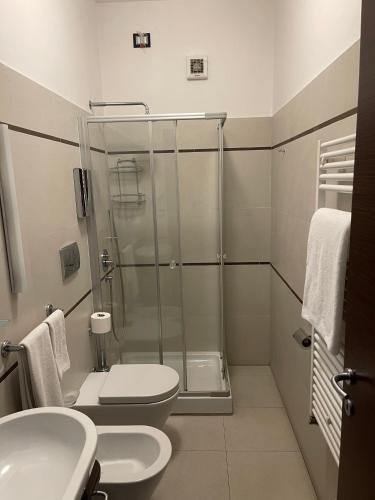 a bathroom with a shower and a toilet and a sink at Rooms affittacamere in Lioni