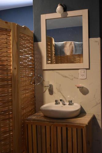 a bathroom with a sink and a mirror at Raíces Hospedaje in Humahuaca