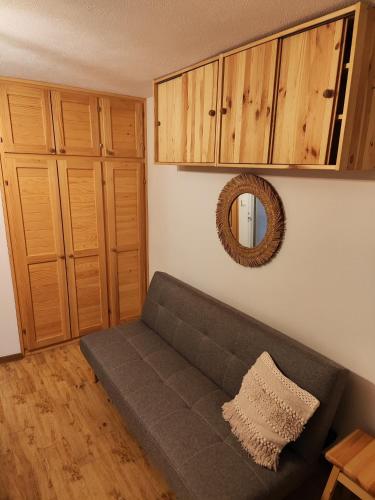 a living room with a couch and a mirror at Lena in Postira