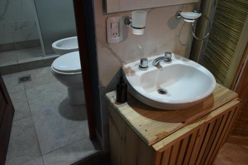 a bathroom with a sink and a toilet at Raíces Hospedaje in Humahuaca