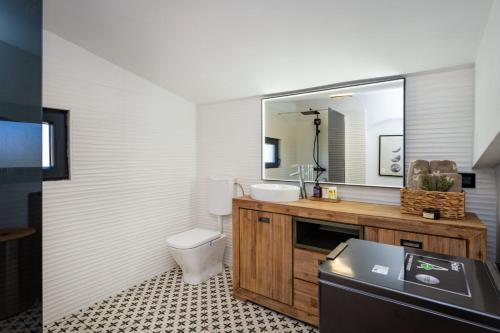 a bathroom with a sink and a toilet and a mirror at Magic view in Sveti Filip i Jakov