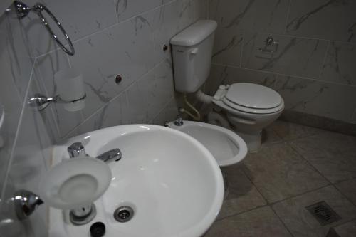 a bathroom with a white sink and a toilet at Raíces Hospedaje in Humahuaca
