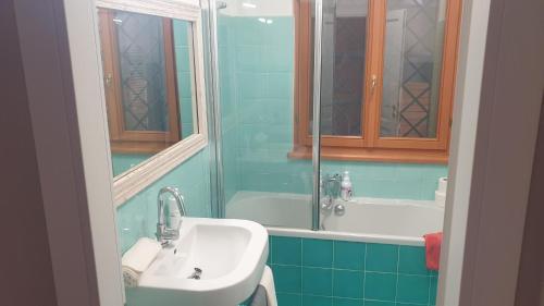 a bathroom with a sink and a bath tub at Villa Domus Roma in Rome