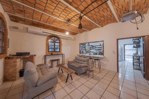 a living room with chairs and a table at El Refugio de Sayulita - Solo Adultos in Sayulita