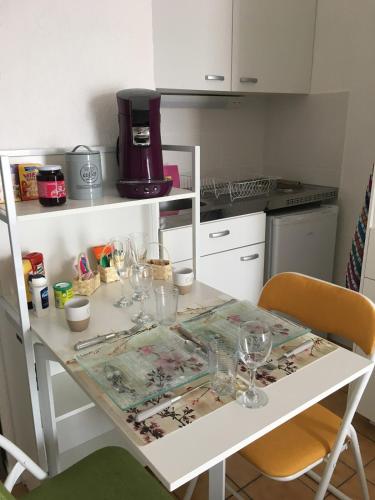 - une table avec des verres à vin dans la cuisine dans l'établissement le studio du centre ville, à Annecy