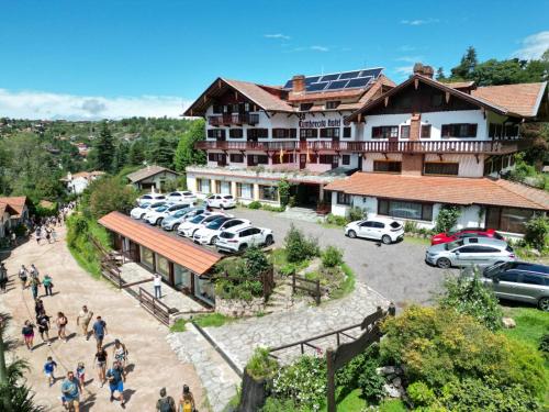 a group of people walking in front of a building at Hotel La Cumbrecita in La Cumbrecita
