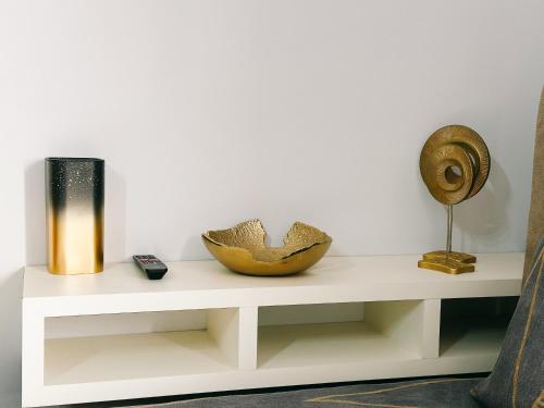 a shelf with two vases and a bowl on it at Luxury studio, Iskele, Cyprus in Iskele