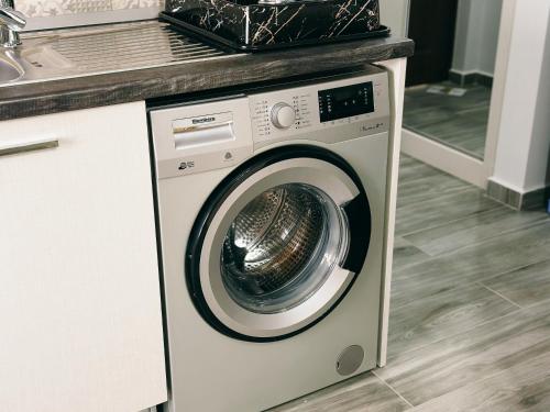 a washing machine in a kitchen with a counter at Luxury studio, Iskele, Cyprus in Iskele