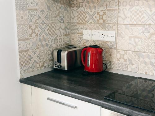 a red appliance sitting on a counter in a kitchen at Luxury studio, Iskele, Cyprus in Iskele