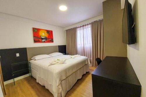 Ένα ή περισσότερα κρεβάτια σε δωμάτιο στο Easy Suites Natal Hotel