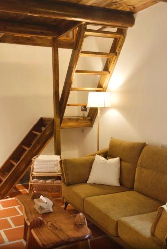 a living room with a couch and a wooden ceiling at 金門Kame民宿 in Lin-ts'o