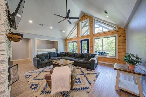 a living room with a couch and a table at Happy Times on Caddo River by StayLage in Glenwood