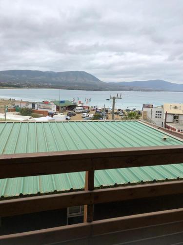 a green roof on a building next to the water at Cabañas brisas del mar Family in Los Molles