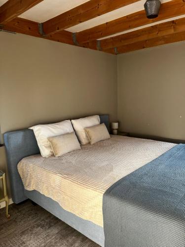 a bedroom with a bed with two pillows on it at Guesthouse Oeyenbos in Knegsel