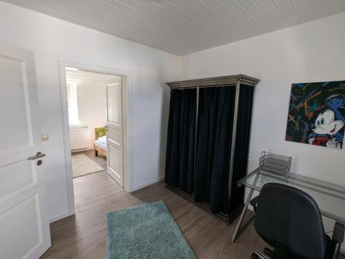 a room with a desk and a table with a window at Mendiger Basalthaus in Mendig