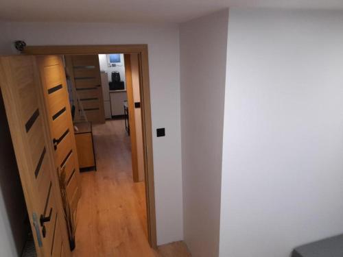 a hallway leading into a room with a door at Apartament typu suite BRIDGE dla 4-5 OSÓB in Płock