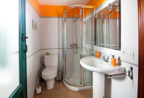 a bathroom with a shower and a toilet and a sink at Casa Claudia in Teguise