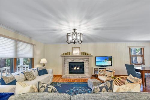 a living room with a couch and a fireplace at Privacy Please! in Saint Simons Island